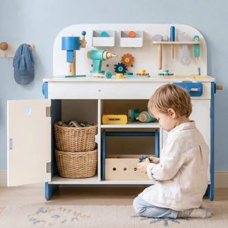 Wooden kids workbench main front view showing tool rail, three cabinets, and removable storage baskets